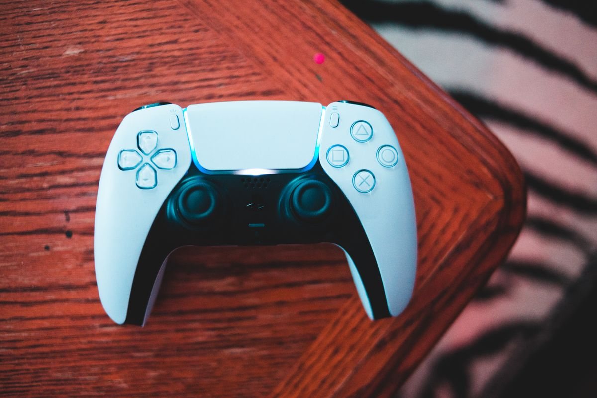 木のテーブルの上に置かれた白いゲームのコントローラー。終わったら決まった場所に戻すルールのイメージ